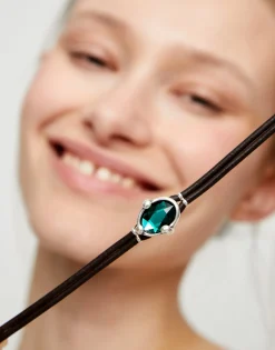 Leather bracelet with green oval faceted crystal